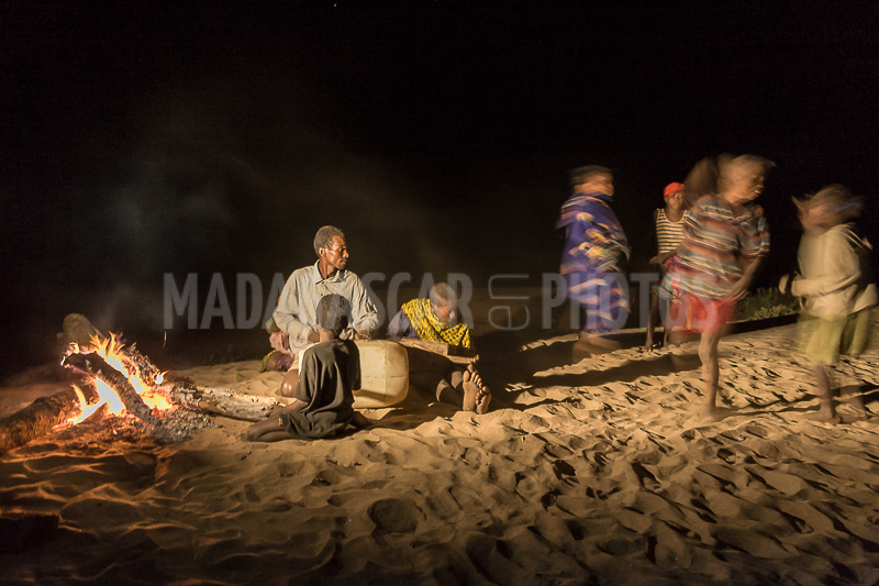 Musicians and dancers around the wood fire on the banks of Tsiribihina river, Madagascar