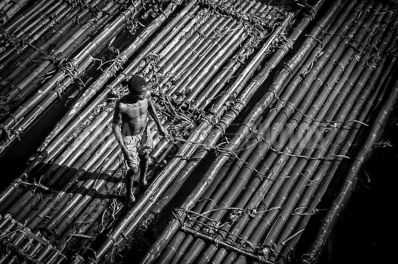 A man on his bamboo raft, Pangalanes Canal, Madagascar